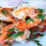 Juicy shrimp garnished with fresh herbs, perfect for seafood lovers.